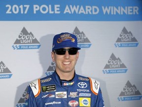 Kyle Busch poses after winning the pole for the NASCAR Cup Series auto race at Pocono Raceway, Sunday, July 30, 2017, in Long Pond, Pa. (AP Photo/Matt Slocum)