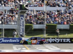 Kyle Busch crosses the finish line to win the NASCAR Cup Series auto race at Pocono Raceway, Sunday, July 30, 2017, in Long Pond, Pa. (AP Photo/Matt Slocum)