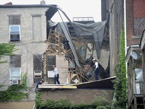 Emergency workers examine an apartment building that collapsed in Washington, Pa., Wednesday July 12, 2017. (Nate Guidry/Pittsburgh Post-Gazette via AP)