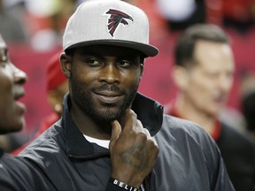 FILE - In this Jan. 1, 2017, file photo, former Atlanta Falcons quarterback Michael Vick stands on the sidelines before NFL football game between the Falcons and the New Orleans Saints in Atlanta. Vick told Fox Sports 1 Monday, July 17, 2017, that former San Francisco 49ers quarterback Colin Kaepernick should get a haircut in order to "try to be more presentable" as he searches for another NFL job. (AP Photo/John Bazemore, File)