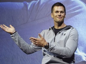 FILE - In this June 22, 2017, file photo, New England Patriots quarterback Tom Brady gestures during a promotional event in Tokyo. The Boston Globe and Fox News reported on Thursday, July 27, 2017, a search for "New York Jets owner" returned Brady as the top result. The glitch was fixed later in the day and Google declined comment on the issue. (AP Photo/Eugene Hoshiko, File)