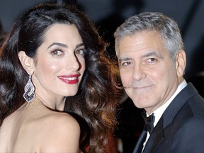 FILE - In this Feb. 24, 2017, file photo actor George Clooney and Amal Clooney arrive at the 42nd Cesar Film Awards ceremony at Salle Pleyel in Paris. George Clooney said in a statement on July 28, 2017, that photographers who captured images of him and his wife, human rights lawyer Amal Clooney, cradling their newborn twins will be "prosecuted to the fullest extent of the law." (AP Photo/Francois Mori, File)
