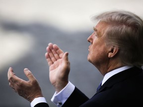 U.S President Donald Trump applauds as he attends the Bastille Day parade in Paris, Friday, July 14, 2017. Paris has tightened security before its annual Bastille Day parade, which this year is being opened by American troops with President Donald Trump as the guest of honor to commemorate the 100th anniversary of the United States' entry into World War I. (AP Photo/Markus Schreiber)