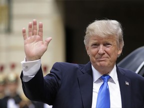 US President Donald Trump waves as he arrives for a meeting with French President Emmanuel Macron at the Elysee Palace in Paris, Thursday, July 13, 2017. Trump will be the parade's guest of honor to commemorate the 100th anniversary of the U.S. entry into World War I. U.S. troops will open the parade Friday as is traditional for the guest of honor. (AP Photo/Markus Schreiber)