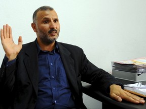 In this photo dated Saturday, June 10, 2017, Hedi Hammami, a former Guantanamo detainee, speaks during an interview with the Associated Press at his lawyer office in Tunis, Tunisia. Two Tunisians freed after years in the U.S. detention center at Guantanamo Bay, Cuba, say they are harassed relentlessly by security forces at home. Neither has ever been charged, and they say they almost yearn to return to captivity in Cuba than face the injustice and isolation they say they now endure.(AP Photo/Hassene Dridi)