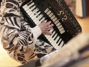 FILE - In this Thursday, Feb. 16, 2017, file photo, a woman plays an accordion as she tries out for a talent contest for seniors at an arts center in Scranton, Pa. While there's nothing you can do or take to ensure you won't get Alzheimer's disease, experts say there are some strategies that might help delay the normal mental decline due to aging. Research on the issue isn't conclusive, but there are hints that getting more exercise and challenging your mind with new ideas and complex activities such as learning to play a musical instrument and going out with friends can help keep the brain sharp. (Jake Danna Stevens/The Times & Tribune via AP, File)