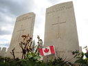 A Canadian flag sits in front of headstone at Tyne Cot Cemetery in Zonnebeke, Belgium. July 31st marks the centenary of Passchendaele, the bloody WW1 battle which saw around 325,000 Allied troops and 260,000 German killed.