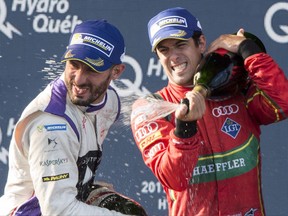 Drivers champion Lucas Di Grassi of Brazil sprays race third place finisher Jose Maria Lopez of Argentina, during victory ceremonies at the Montreal Formula ePrix electric car race Sunday, July 30, 2017 in Montreal. The mayor of Montreal is expressing satisfaction with the city's first-ever Formula E race, which he says drew 45,000 spectators to the downtown core during the weekend. THE CANADIAN PRESS/Paul Chiasson