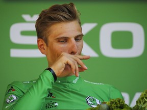 Germany's Marcel Kittel, wearing the best sprinter's green jersey, reacts on the podium after the sixteenth stage of the Tour de France cycling race over 165 kilometers (102.5 miles) with start in Le Puy-en-Velay and finish in Romans-sur-Isere, France, Tuesday, July 18, 2017. Kittel lost contact with the group of leaders with his main rival for the green jersey Australia's Michael Matthews. (AP Photo/Peter Dejong)