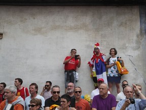 Spectators watch the riders arrive for the start of the thirteenth stage of the Tour de France cycling race over 101 kilometers (62.8 miles) with start in Saint-Girons and finish in Foix, France, Sunday, July 9, 2017. (AP Photo/Christophe Ena)