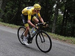 Britain's Chris Froome, wearing the overall leader's yellow jersey, speeds downhill during the ninth stage of the Tour de France cycling race over 181.5 kilometers (112.8 miles) with start in Nantua and finish in Chambery, France, Sunday, July 9, 2017. (AP Photo/Christophe Ena)