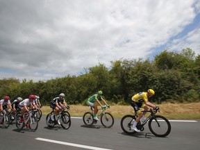 Britain's Chris Froome, wearing the overall leader's yellow jersey, and Germany's Marcel Kittel, wearing the best sprinter's green jersey, ride in the pack during the eleventh stage of the Tour de France cycling race over 203.5 kilometers (126.5 miles) with start in Eymet and finish in Pau, France, Wednesday, July 12, 2017. (AP Photo/Christophe Ena)
