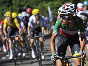 Stage winner Fabio Aru of Italy, right, turns back to see how much advance he has on the group of favorites after breaking away in the fifth stage of the Tour de France cycling race over 160.5 kilometers (99.7 miles) with start in Vittel and finish in La Planche des Belles Filles, France, Wednesday, July 5, 2017. (Lionel Bonaventure, Pool via AP)