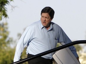 FILE- In this Aug. 4, 2011, file photo, Lyle Jeffs, brother of polygamous religious leader Warren Jeffs, arrives carrying a box of defense materials in the sexual assault trial against Warren at the Tom Green County Courthouse in San Angelo, Texas. A pair of pawn shop workers who provided a key tip that helped authorities capture Lyle Jeffs will split a $50,000 reward from the FBI, the agency revealed Monday, July 31, 2017. (AP Photo/Tony Gutierrez, File)