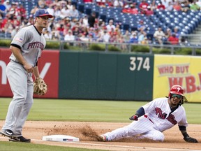Philadelphia Phillies' Freddy Galvis, right, steals third base as Pittsburgh Pirates third baseman David Freese, left, looks on during the first inning of a baseball game, Tuesday, July 4, 2017, in Philadelphia. (AP Photo/Chris Szagola)