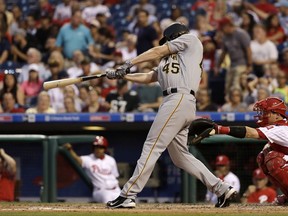 Pittsburgh Pirates' Gerrit Cole follows through on a a two-run single off Philadelphia Phillies starting pitcher Ben Lively during the fourth inning of a baseball game, Wednesday, July 5, 2017, in Philadelphia. At right is catcher Andrew Knapp. (AP Photo/Matt Slocum)