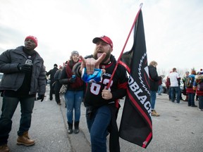 In this Nov. 27, 2016 file photo, an Ottawa Redblacks fan awaits the Grey Cup game in Toronto.