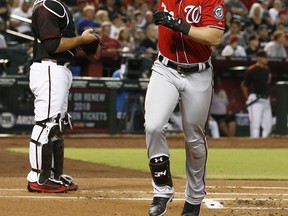 Washington Nationals' Bryce Harper, right, celebrates his home run as Arizona Diamondbacks' Chris Iannetta, left, stands at home plate during the first inning of a baseball game Saturday, July 22, 2017, in Phoenix. (AP Photo/Ross D. Franklin)