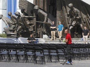 Workers prepare chairs for the audience  in front of the monument to the heroes of the 1944 Warsaw Rising in Krasinski Square where U.S. President Donald Trump will speak in Warsaw, Poland, Wednesday, July 5, 2017. Trump will be in Warsaw before traveling to Germany for a G-20 summit of top world leaders. (AP Photo/Czarek Sokolowski)