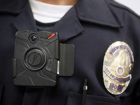 A Los Angeles police officer demonstrates the use of a body camera.