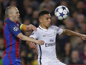 FILE- In this Wednesday March 8, 2017 file photo, PSG's Marquinhos is challenged by Barcelona's Andres Iniesta, left, during the Champion's League round of 16, second leg soccer match between FC Barcelona and Paris Saint Germain at the Camp Nou stadium in Barcelona, Spain. Brazilian center half Marquinhos has signed a new three-year deal with Paris Saint-Germain, Saturday, July 1, 2017, tying him to the club until 2022. (AP Photo/Manu Fernandez, File)