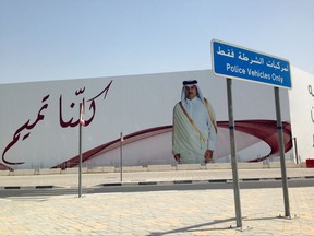 An image of Qatar's emir, Sheikh Tamim bin Hamad Al Thani, graces a billboard featuring the slogan "We are all Tamim" in Doha, Qatar, on Monday, July 3, 2017. A group of Arab nations has extended a deadline for Qatar to respond to their list of demands in a diplomatic crisis roiling the Gulf by 48 hours, saying Kuwait's emir requested the delay as part of his efforts to mediate the dispute. (AP Photo/Maggie Hyde)