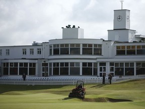 A groundsman prepares the 18th green ahead of the final round of the British Open Golf Championship, at Royal Birkdale, Southport, England, Sunday July 23, 2017. (AP Photo/Dave Thompson)