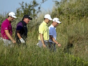 Spain's Jon Rahm, left with Phil Mickelson of the United States, Jordan Spieth of the United States and Justin Thomas of the United States talk together as they walk to the 3rd tee during a practice round ahead of the British Open Golf Championship, at Royal Birkdale, Southport, England Tuesday, July 18, 2017. (AP Photo/Dave Thompson)