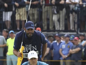 Jordan Spieth of the United States and his caddie Michael Greiler line up a putt on the 4th green during the final round of the British Open Golf Championship, at Royal Birkdale, Southport, England, Sunday July 23, 2017. (AP Photo/Peter Morrison)