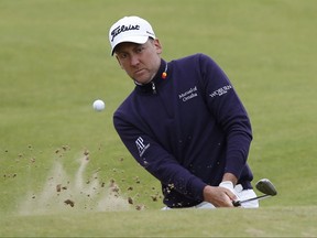England's Ian Poulter chips out of a bunker onto the 17th green during the first round of the British Open Golf Championship, at Royal Birkdale, Southport, England Thursday, July 20, 2017. (AP Photo/Alastair Grant)