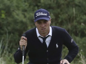 Justin Thomas of the US lines up a putt on the 8th green during the first round of the British Open Golf Championship, at Royal Birkdale, Southport, England Thursday, July 20, 2017. (AP Photo/Peter Morrison)