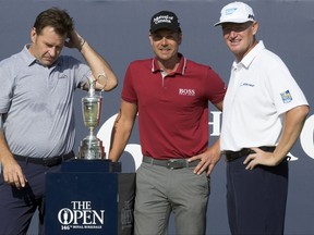 England's Nick Faldo, left, Sweden's Henrik Stenson and South Africa's Ernie Els, right, pose on the 1st tee with the trophy prior to a practice round ahead of the British Open Golf Championship, at Royal Birkdale, Southport, England Tuesday, July 18, 2017. (AP Photo)