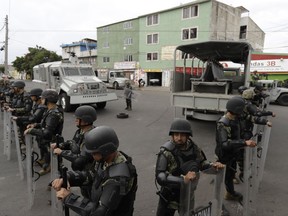 Marines block off the area where the suspected leader of a drug gang and seven others were killed, according to the Navy, in southern Mexico City, Thursday, July 20, 2017. In a statement Thursday, the Navy said a gang of street-level drug dealers operated in the Tlahuac and Iztapalapa districts on the city's south and east sides, where it dealt drugs, as well as carried out kidnappings, extortion and murder. (AP Photo/Rebecca Blackwell)