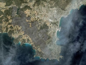 This satellite imagery, provided Friday, July 28, 2017 by Airbus Defence and Space, shows the devastation (in grey) wrought by wildfires near Bormes-les-Mimosas, French Riviera. Firefighters have contained one of the largest fires in southern France and authorities have cleared thousands of evacuees to return to their homes and campsites. (Cnes 2017 - Distribution Airbus DS via AP)