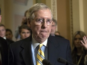 In this June 27, 2017, photo Senate Majority Leader Mitch McConnell, R-Ky., tells reporters he is delaying a vote on the Republican health care bill while GOP leadership works toward getting enough votes, at the Capitol in Washington. President Donald Trump and his Republican Party have so far failed to deliver core campaign promises on health care, taxes, infrastructure and border security. But on the ground from New York to Louisiana to Iowa, Republicans are increasingly blaming GOP leaders in Congress _ not the White House _ for the party's governing challenges. (AP Photo/J. Scott Applewhite)
