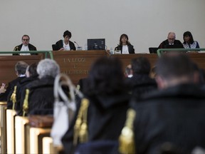 Judges attend a corruption trial in Rome, Thursday,  July 20, 2017. An Italian court has found 46 defendants guilty in a wide ranging corruption trial that revealed a system of kick-backs and intimidation to gain control of city contracts.  But the court did not convict the defendants of mafia-style association, a key element of prosecutor's case and which would have been the first in Italy to unite findings of corruption with the trappings of organized crime. (Massimo Percossi/ANSA via AP)