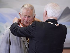 Prince Charles receives the Extraordinary Companion to the Order of Canada medal from Governor General David Johnston at Rideau Hall in Ottawa on Saturday, July 1, 2017. THE CANADIAN PRESS/Adrian Wyld