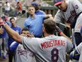 Kansas City Royals' Mike Moustakas is congratulated in the dugout after hitting a solo home run on a pitch from the Seattle Mariners' Andrew Moore during the second inning of a baseball game, Monday, July 3, 2017, in Seattle. (AP Photo/John Froschauer)