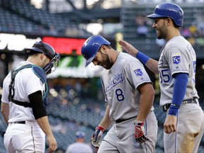 Kansas City Royals' Mike Moustakas (8) gets a pat from Eric Hosmer, near Seattle Mariners catcher Mike Zunino, after Moustakas' two-run home run during the first inning of a baseball game Wednesday, July 5, 2017, in Seattle. (AP Photo/Elaine Thompson)