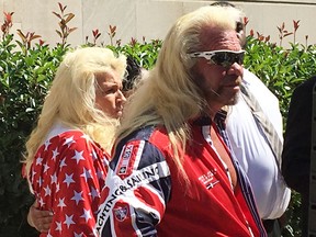 Duane "Dog" Chapman, center, joins the family of Christian Rodgers and their lawyers Monday, July 31, 2017, as they announce a wrongful death lawsuit that claims New Jersey's new bail reform measures are to blame for Rodgers' shooting death in April 2017, in Trenton, N.J. Chapman, the former star of the "Dog the Bounty Hunter" television show, has been an outspoken critic of the reforms, which proponents say are meant to keep defendants from being stuck in jail mainly because they can't afford bail. Defendants named in the suit include Gov. Chris Christie, who has championed the reforms, and state Attorney General Christopher Porrino. (AP Photo/Bruce Shipkowski)