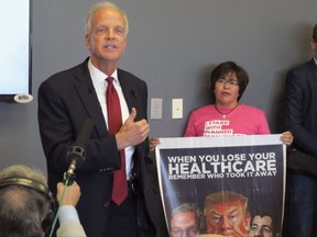 U.S. Sen. Jerry Moran, left, R-Kan., answers questions about health care during a town hall meeting, Thursday, July 6, 2017, in the small town of Palco, Kan. Standing to his right is Yaneth Poarch, an Olathe, Kan., college student and Planned Parenthood supporter. (AP Photo/John Hanna)