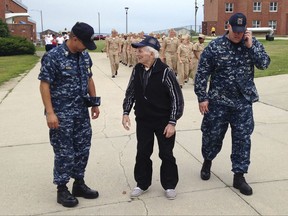 WWII veteran Edmund DelBarone, center, chats with Command Master Chief Paul King, left, during a tour at Naval Station Newport, in Newport, R.I., Thursday July 27, 2017. DelBarone, a 96-year-old World War II veteran, once dreamed of returning to a Navy installation to reminisce about his naval career, and help of a nonprofit it has become a reality. (AP Photo/Jennifer McDermott)
