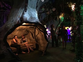 Recent high school graduates Abbigail Deason and Grace Branscum, both 18, of Oklahoma City relax inside Meow Wolf's mazelike exhibition space in Santa Fe, N.M., on Friday, July 14, 2017. The startup company behind the popular art installation is seeking out small-scale Internet investors as it lays the groundwork for expansion to major metropolitan markets.