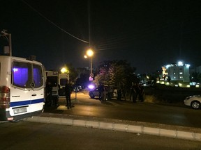 Security officials park near the approach toward the Israeli embassy in Amman, Jordan, on Sunday, June 23, 2017, in the aftermath of a shooting that left a Jordanian man dead and an Israeli man wounded. A security official confirmed a Jordanian had been killed and an Israeli wounded, but would not provide further details. He spoke on condition of anonymity because he was not authorized to discuss the incident with the media. (AP Photo/Omar Akour)