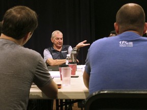 Former UConn NCAA college basketball coach Jim Calhoun, center, speaks to the cast and crew of the play "Exposure" at the Eugene O'Neill Theater Center, Tuesday, July 11, 2017, in Waterford, Conn. Calhoun is serving as an adviser for the play about the darker side of college basketball recruiting. (AP Photo/Pat Eaton-Robb)