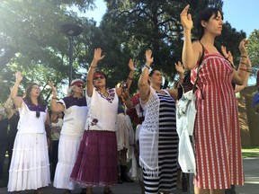 Participants pray during in a morning ceremony on Monday, July 17, 2017, at the University of New Mexico in Albuquerque as part of school's annual course on Curanderismo indigenous healing methods from the American Southwest and Latin America. A new textbook by the workshop's founder, Eliseo "Cheo" Torres, was released this month to coincide with the annual gathering. (AP Photo/Russell Contreras)