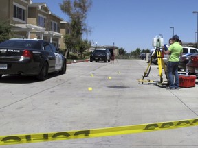 Investigators check a crime scene where two police officers and a burglar were shot on Monday, July 31, 2017, at an apartment complex in Los Banos, Calif. Authorities say the two police officers and a burglary suspect were shot in a struggle that erupted when the officers responded to a break-in report at the apartment. (AP Photo/Scott Smith)