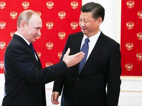 Russian President Vladimir Putin, left, greets China's President Xi Jinping prior to their dinner in the Kremlin in Moscow, Russia, Monday, July 3, 2017.  Chinese President has arrived in Russia for talks focusing on expanding cooperation with Moscow just as tensions between U.S. and China have flared up. (Sergei Chirikov/Pool Photo via AP)