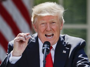 FILE In this Thursday, June 1, 2017 file photo President Donald Trump gestures while speaking about the U.S. role in the Paris climate change accord, in the Rose Garden of the White House in Washington. (AP Photo/Pablo Martinez Monsivais, File)