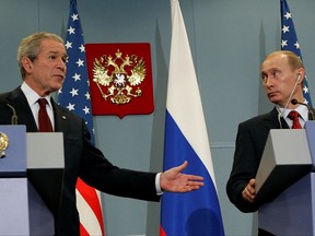 FILE In this Sunday, April 6, 2008 file photo Russian President Vladimir Putin , right, and U.S. President George W. Bush look on during their news conference in the Black Sea resort city of Sochi, southern Russia. (AP Photo/Alexander Zemlianichenko, File)